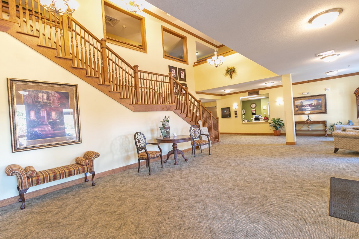 Spacious lobby area with elegant staircase and comfortable seating.