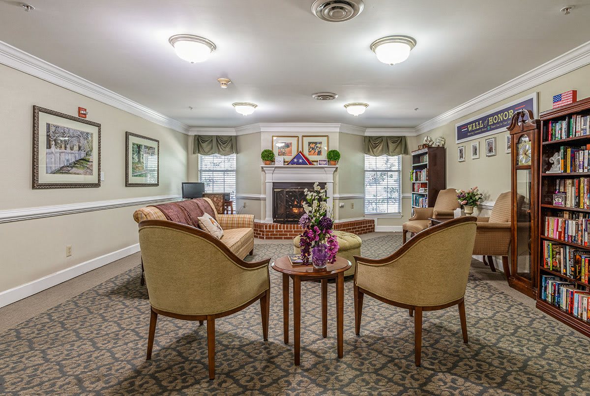 A cozy living room with elegant furniture and a central fireplace, creating a welcoming ambiance.