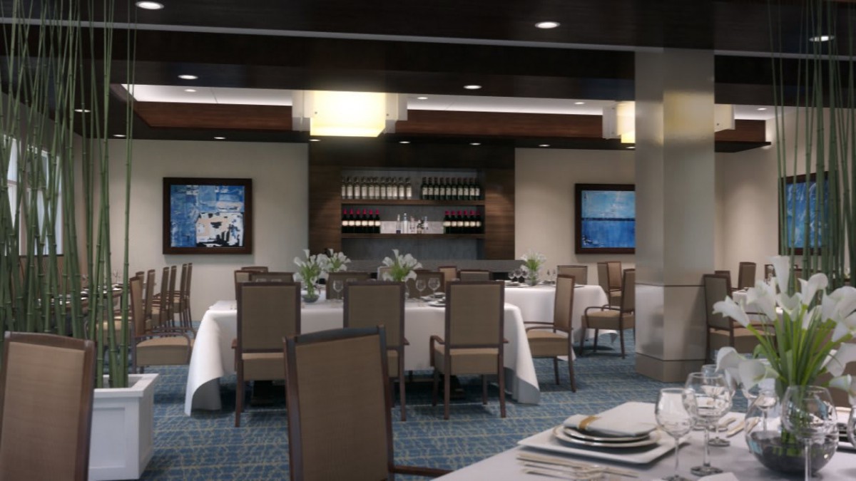 A cozy dining area featuring elegantly set tables and wine display.