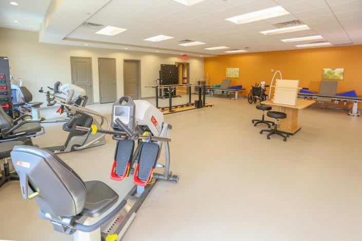 A rehabilitation center equipped with fitness machines and therapy equipment.
