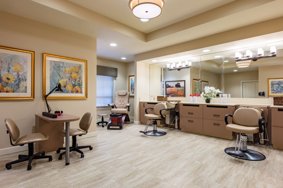 A well-furnished salon interior with chairs, mirrors, and tasteful decor.