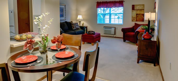 A cozy living room with dining area set up, featuring comfortable seating and tasteful decor.