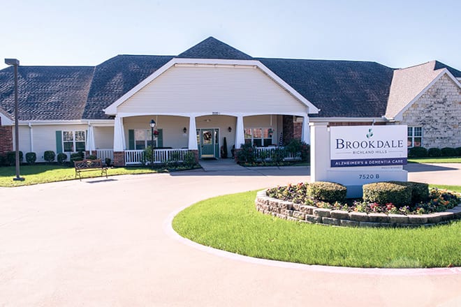 A large building with a welcoming entrance and a sign indicating the name of the facility.
