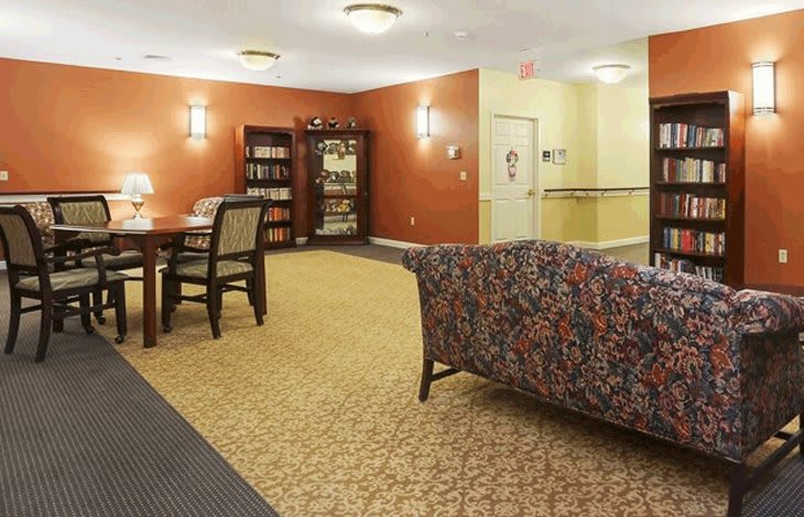 A cozy lounge area with comfortable seating and a bookshelf.