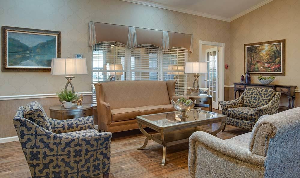 A stylish living room featuring elegant furniture with sofas, armchairs, and a central coffee table.