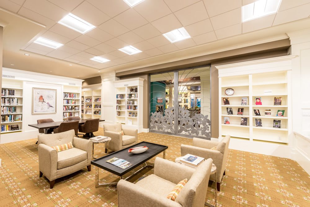 A cozy and modern library interior with comfortable seating and well-organized bookshelves.