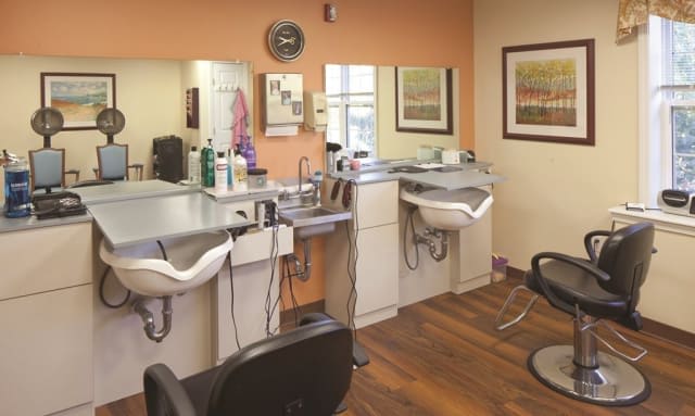A cozy hair salon interior with styling chairs and mirrors.