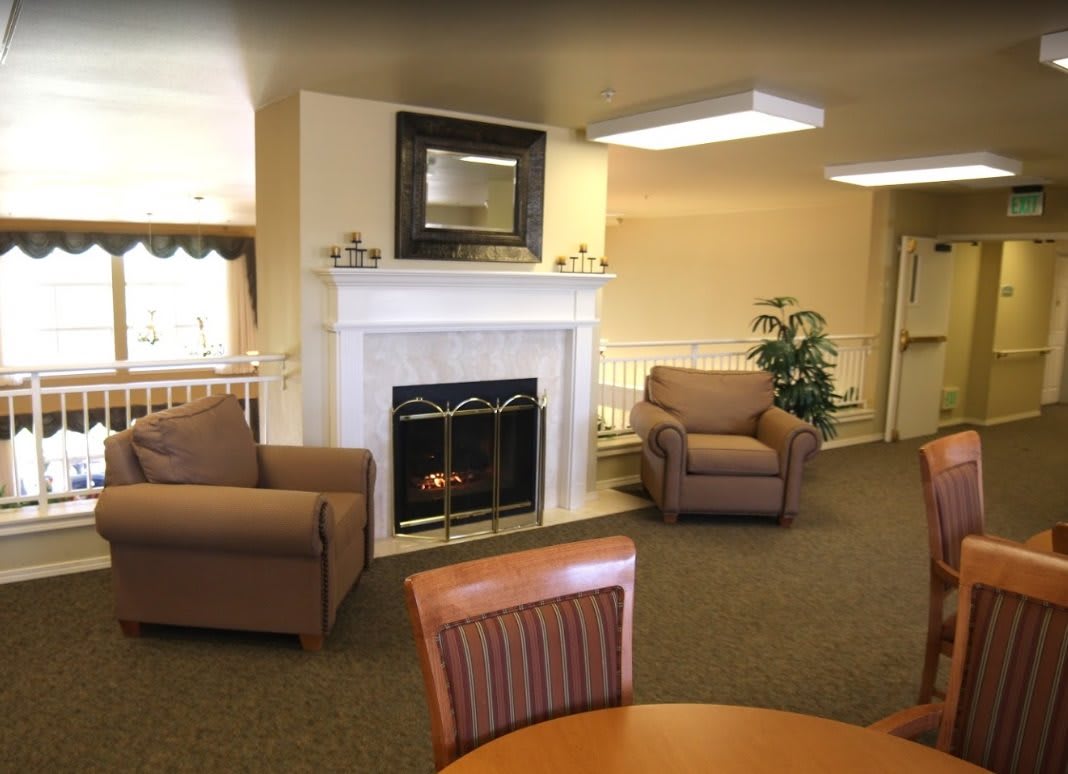 A cozy living room with a fireplace and comfortable seating.