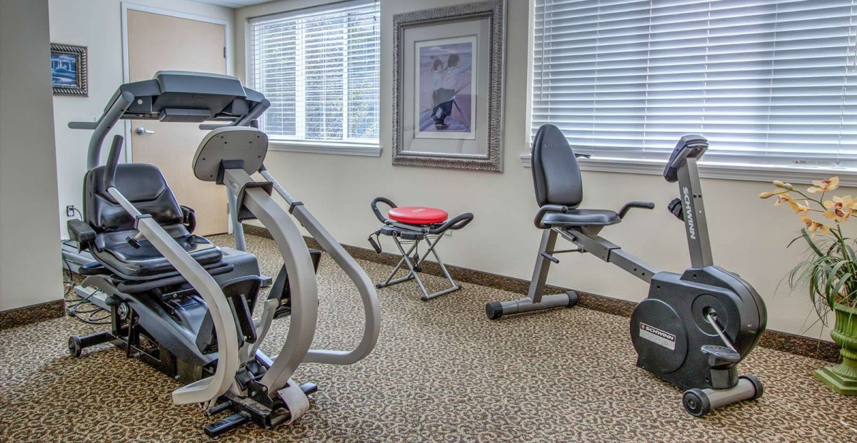 A small gym room with various exercise equipment.