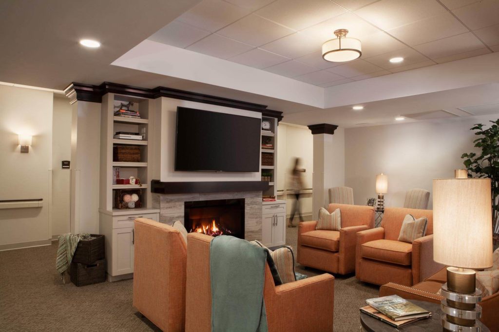 A cozy living room featuring a fireplace, television, and comfortable seating.