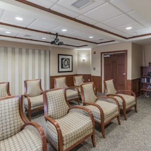 A neatly arranged waiting room with patterned chairs and elegant decor.