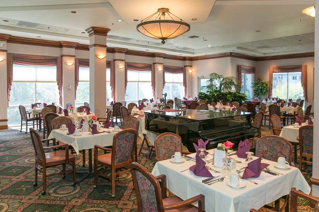 An elegantly decorated restaurant interior with neatly arranged dining tables and chairs.