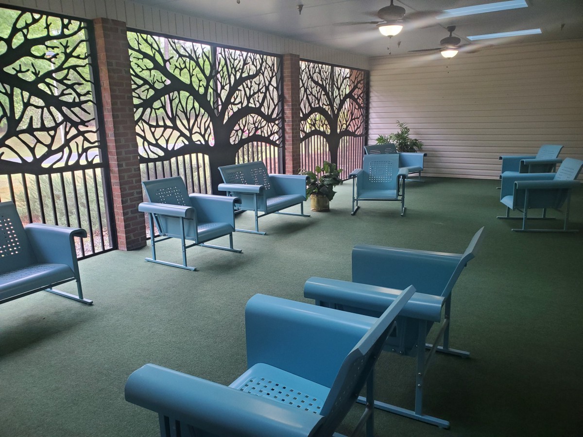 A modern waiting area featuring blue chairs and decorative wall panels.