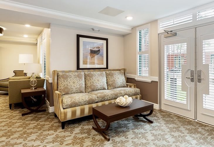 A cozy living room with a patterned sofa, a sleek coffee table, and elegant decor.