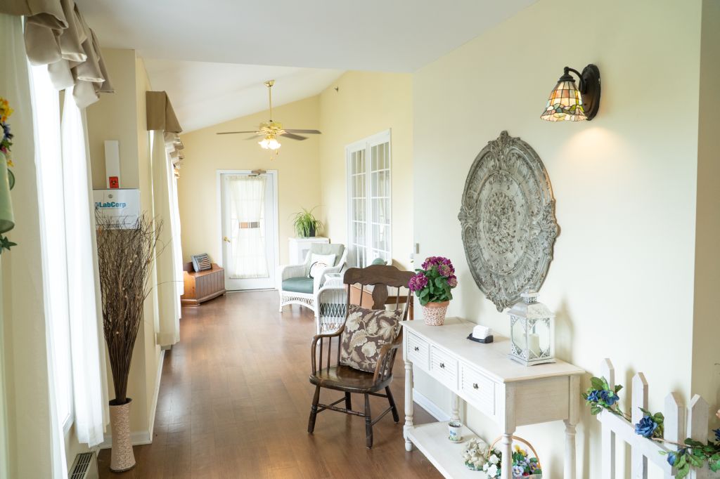 A cozy, well-lit hallway featuring elegant furniture and wall decor.