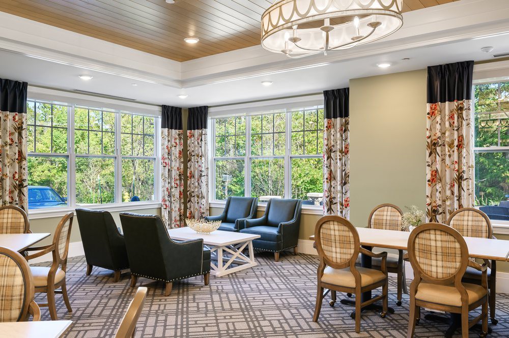 Elegant living room with a cozy seating area and large windows.