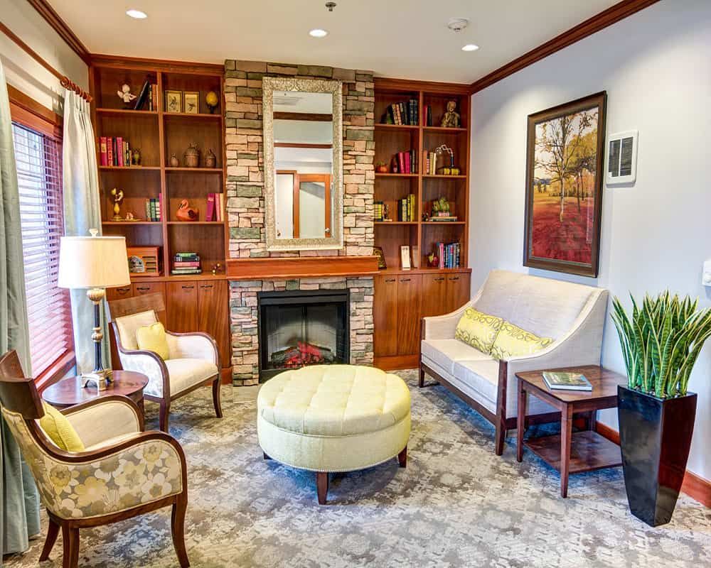 A cozy living room with a fireplace, comfortable seating, and elegant decor.