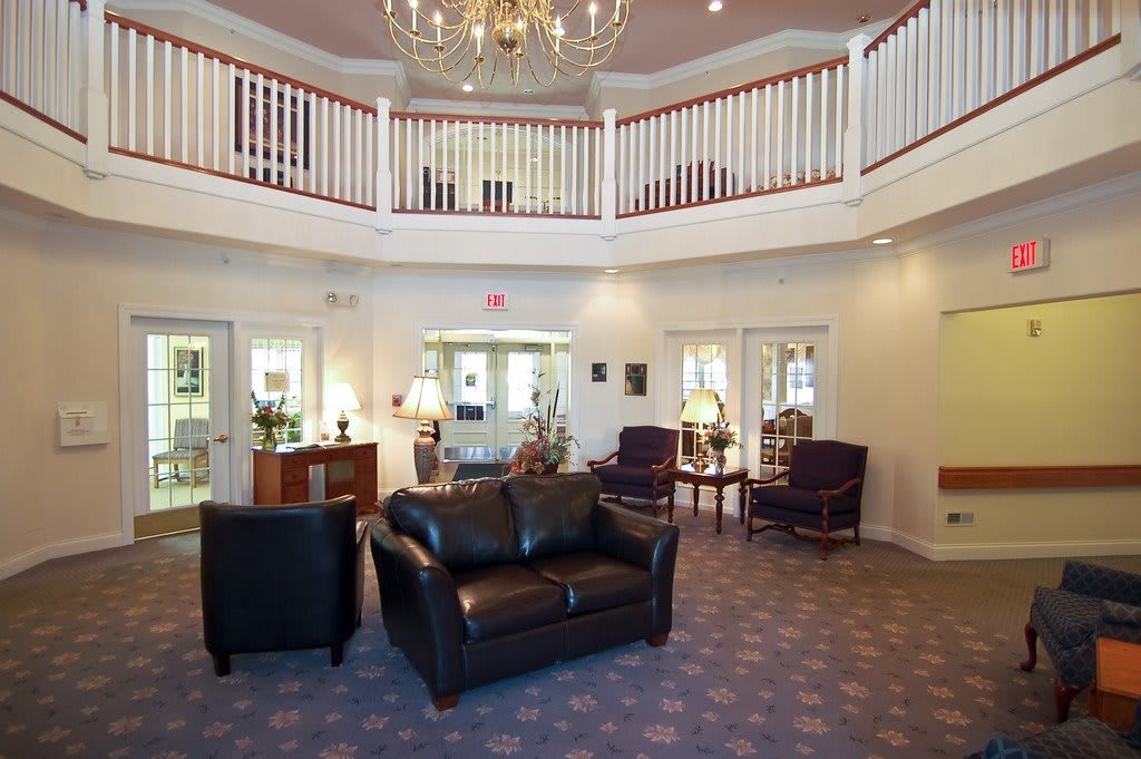 Elegant lobby with a chandelier and comfortable seating area.