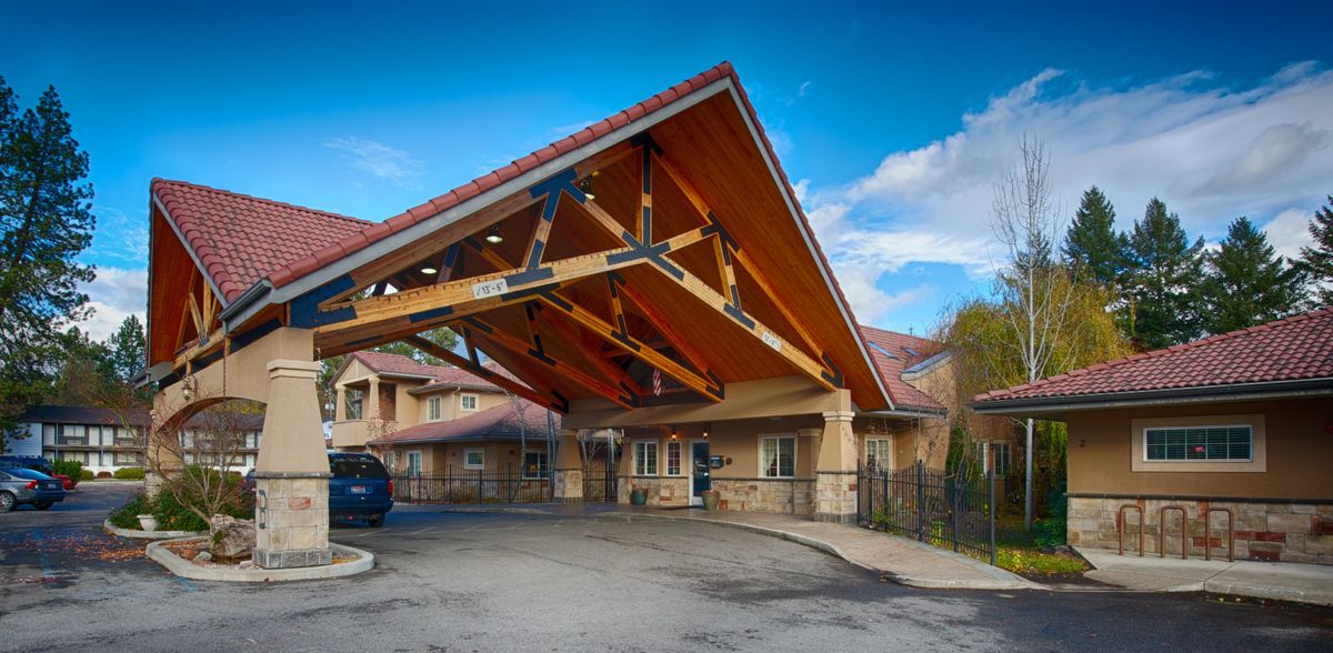 A residential building with a distinctive wooden canopy at the entrance.