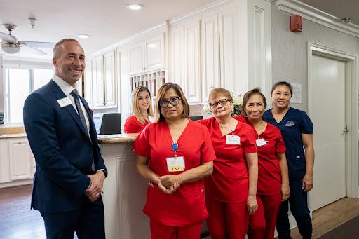 A dedicated healthcare team posing for a photo at the reception of their facility.