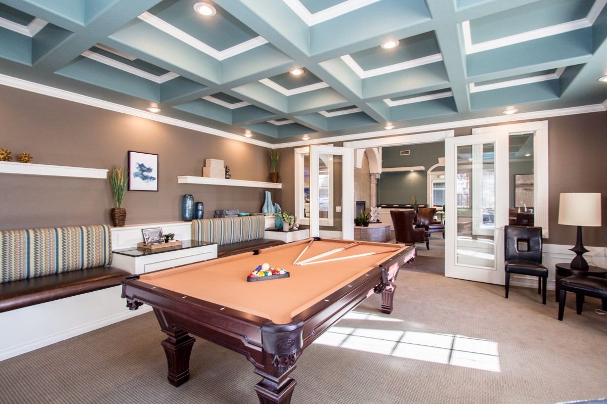 A stylish billiards room featuring a pool table and modern interior design.