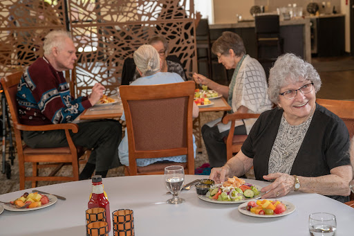 A group of seniors enjoying a meal together in a cozy dining environment.