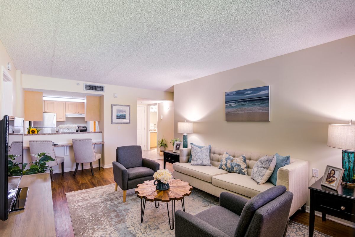 A cozy living room with a comfortable sofa, stylish chairs, and elegant decor.