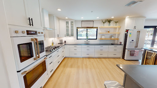 A bright and modern kitchen featuring white cabinetry and a spacious layout.