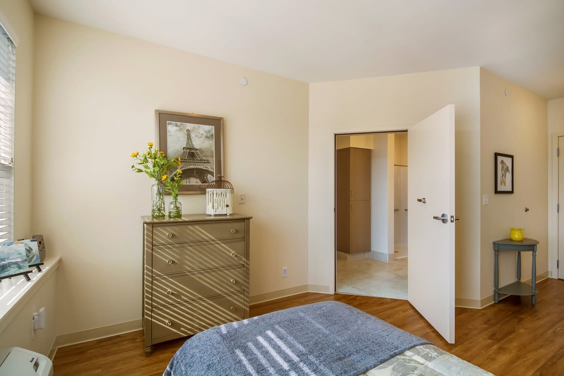 A cozy bedroom with a stylish dresser and minimalistic decor.