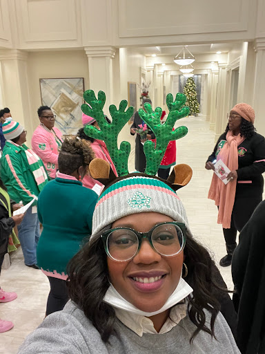 A cheerful gathering celebrating the holiday season with festive hats and smiles.