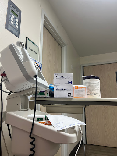 A medical workspace with equipment and medication.