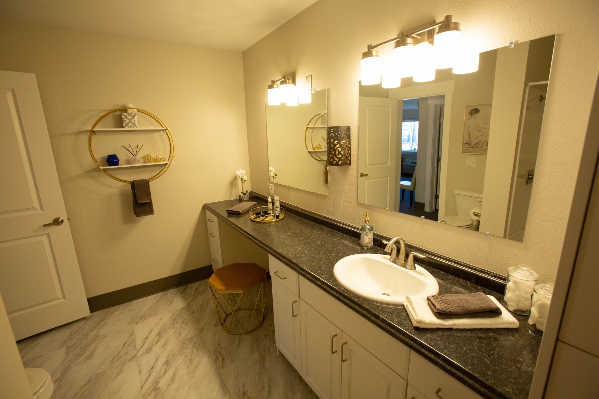 A modern bathroom with a spacious countertop and elegant lighting.