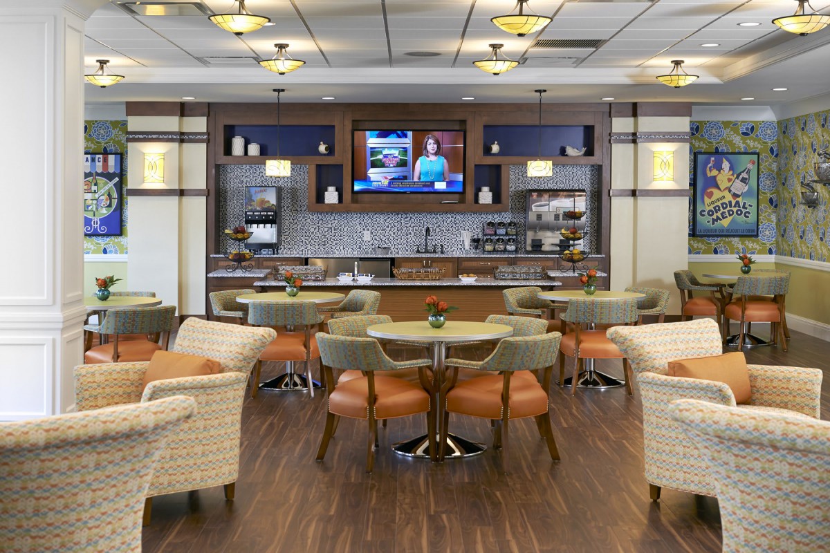 A modern restaurant interior with a seating area and bar.