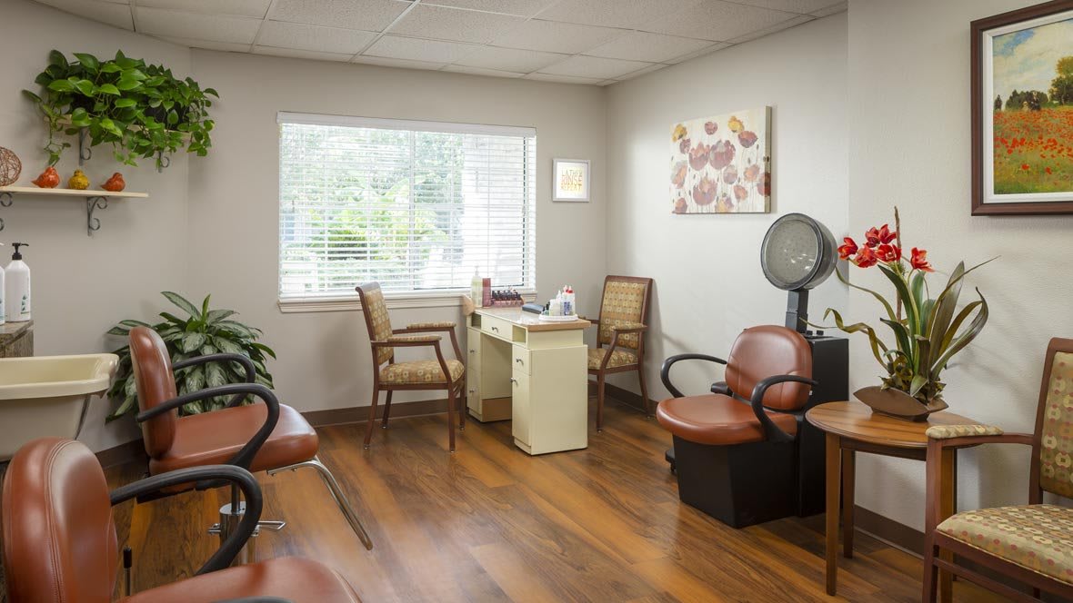 A cozy salon waiting area with chairs and a hair dryer.