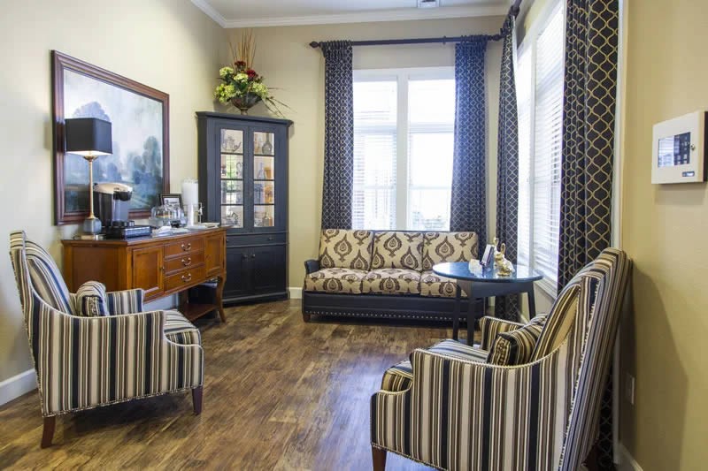 A cozy living room with patterned furniture and elegant decor.