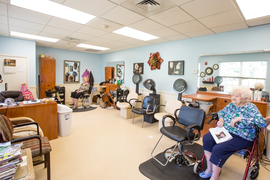 A cozy hair salon with styling chairs, mirrors, and hairdressing equipment.