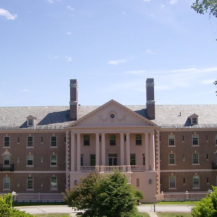 A historic university building with brick facade and symmetrical columns.