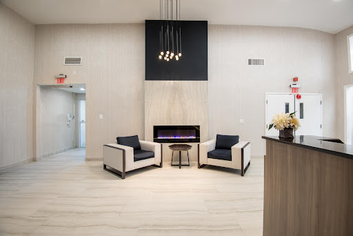 A modern lounge area featuring stylish chairs and a cozy fireplace.