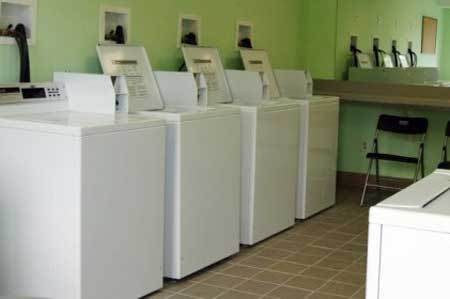 A row of washing machines in a laundromat.