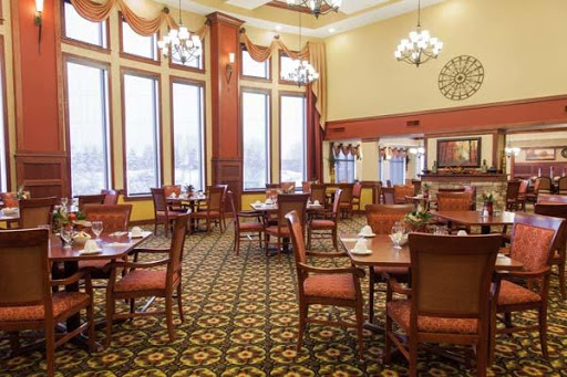 An elegant dining room with wooden furniture and large windows, offering a cozy atmosphere.