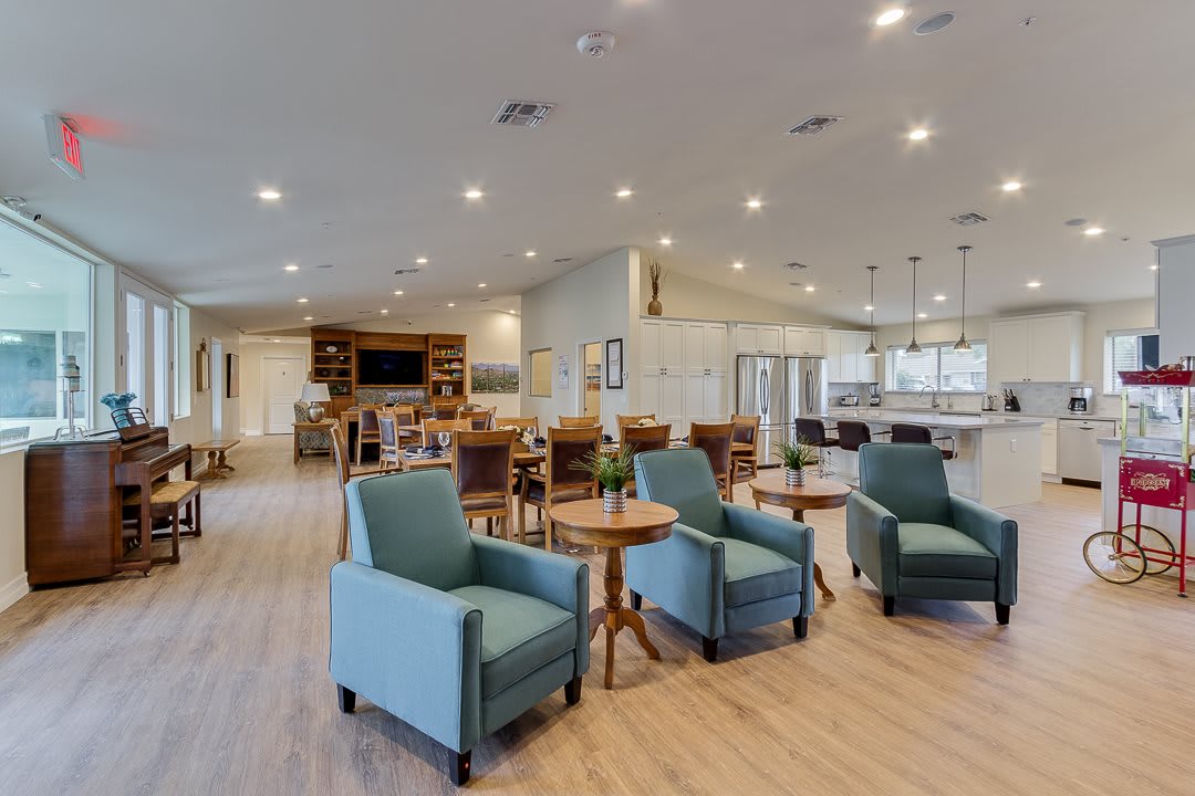 A spacious and modern living area featuring comfortable seating and elegant lighting.