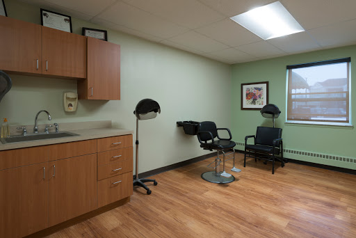 A clean, organized medical or salon room featuring chairs and modern furnishings.