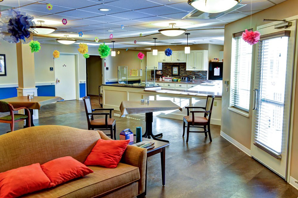 A community living room with colorful decorations, comfortable seating, and a spacious layout.