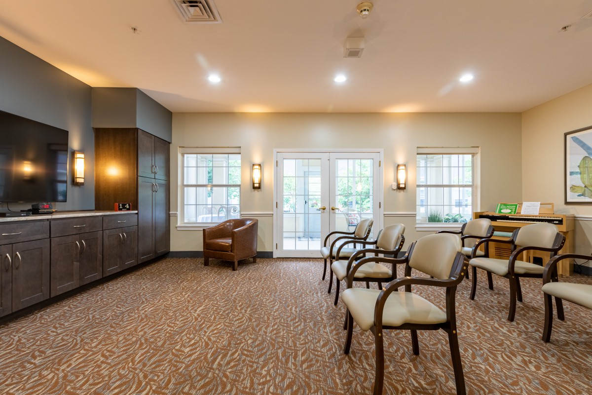 A spacious waiting area with arranged chairs and natural lighting.