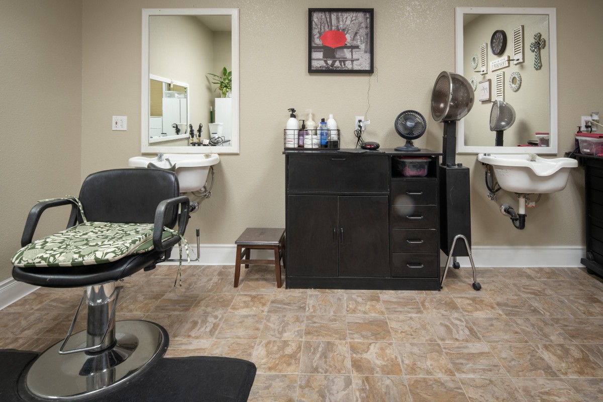 A well-organized barber salon with chairs, mirrors, and hair products.