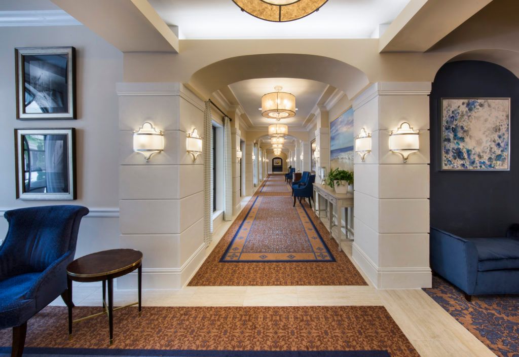 A luxurious hotel hallway with elegant lighting and decor.