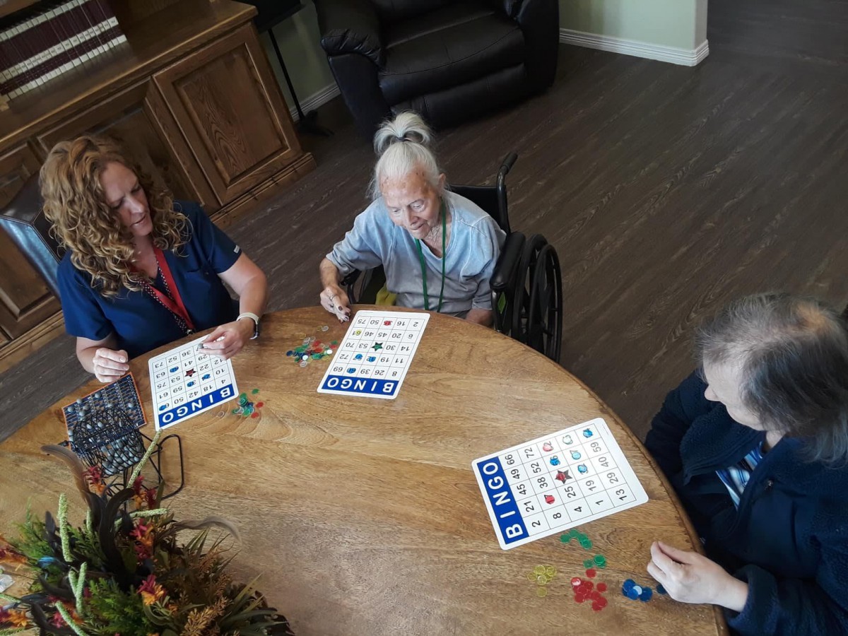 A group of seniors enjoying a game of bingo at a table.