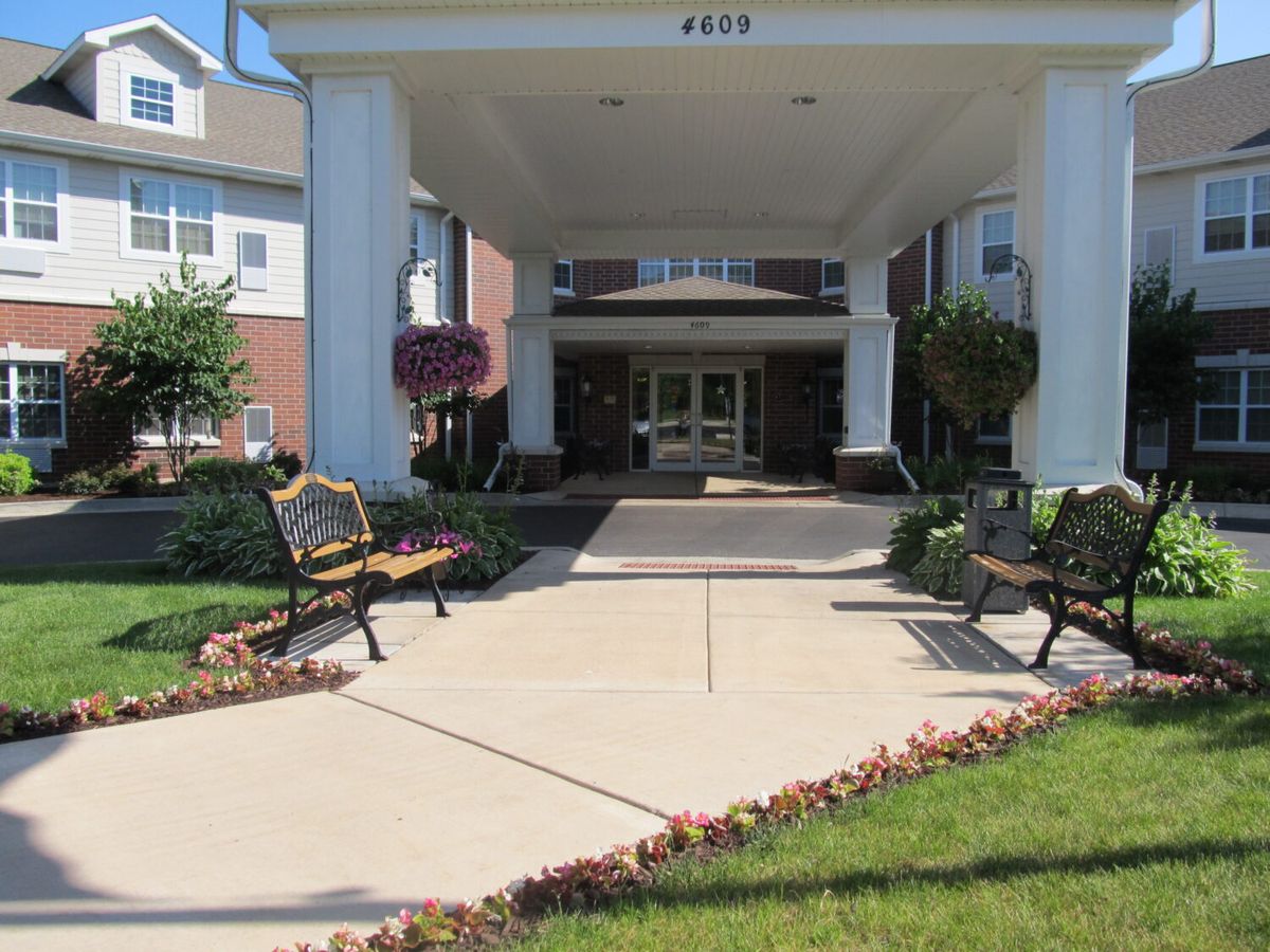 Entrance to a building with benches and landscaped area