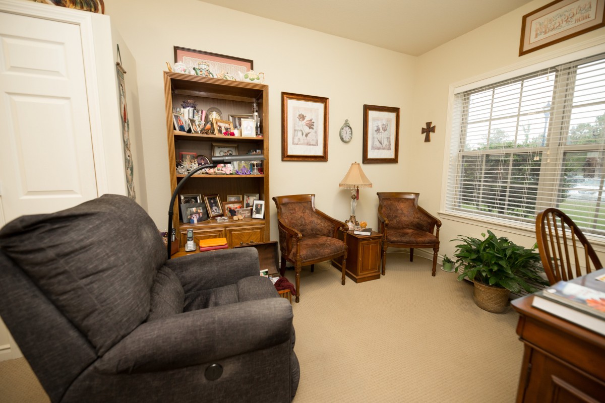 A cozy living room with comfortable seating and decorative elements.