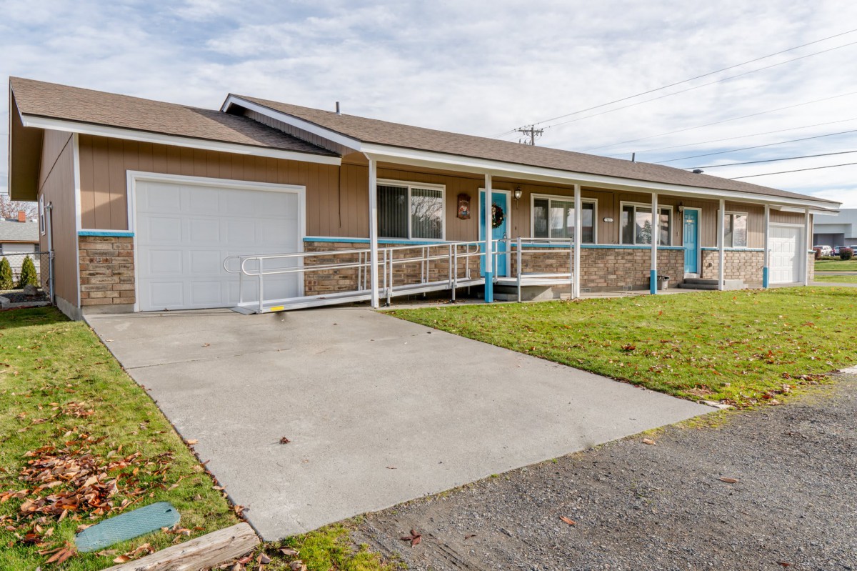 A single-story ranch-style house with a driveway, garage, and front porch.
